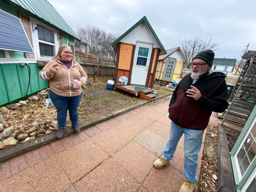 Gene Cox speaks with Brenda Konkel, president of Occupy Madison and executive director of Madison Area Care for the Homeless OneHealth. Occupy Madison provides tiny houses for people experiencing homelessness in Madison, Wisconsin. Gene Cox speaks with Brenda Konkel, president of Occupy Madison and executive director of Madison Area Care for the Homeless OneHealth. Occupy Madison provides tiny houses for people experiencing homelessness in Madison, Wisconsin. (Giles Bruce for KHN)