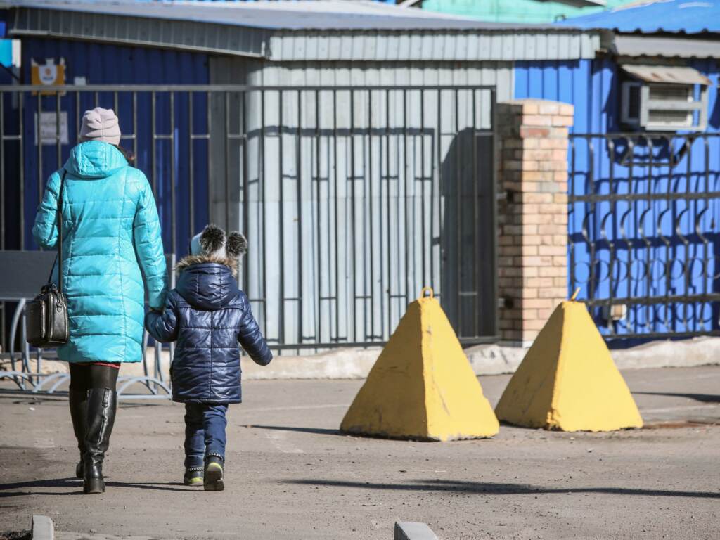 Russia has created a list of Ukrainian civilians who would be detained or killed in case of an invasion, the U.S. says. Here, people walk past anti-tank barriers in the town of Avdiivka, on the eastern Ukraine front-line with Russia-backed separatists. People walk past anti-tank barriers in the Donetsk region town of Avdiivka