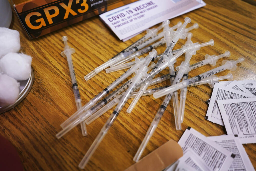 Virus Outbreak Vaccines Booster COVID-19 vaccine syringes