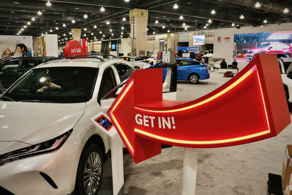 2022 03 04-e lee-philadelphia pennsylvania convention center-auto show get in A sign invites visitors to sit in the cars at the Philadelphia Auto Show. (Emma Lee/WHYY)