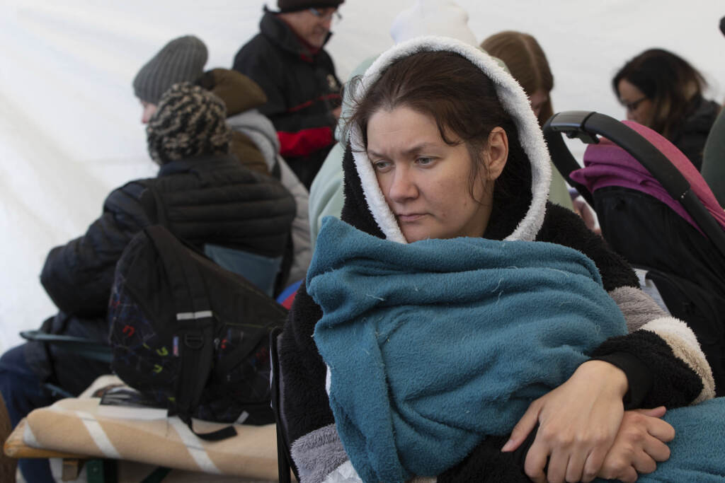 Poland Russia Ukraine War Alina Gafarova holds her 1-year-old daughter Zahra inside a tent after fleeing Irpin, Ukraine at the border crossing in Medyka, Poland, Poland, Tuesday, March 8, 2022. Russia's invasion of Ukraine has set off the largest mass migration in Europe in decades, with more than 1.5 million people having crossed from Ukraine into neighboring countries. (AP Photo/Visar Kryeziu)