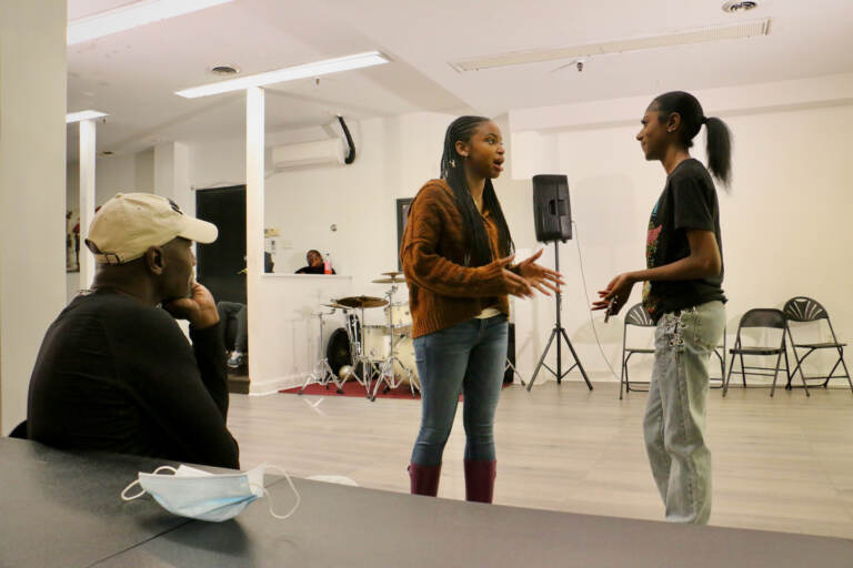 Playwright and director Bilal Islam watches a rehearsal of Childhoodslost Chronicles. (Emma Lee/WHYY)