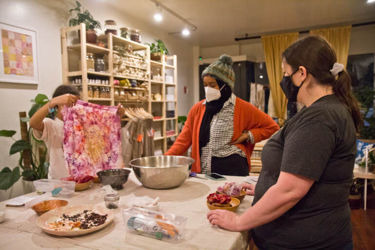 People participate in a fabric dyeing workshop at Modest Transitions