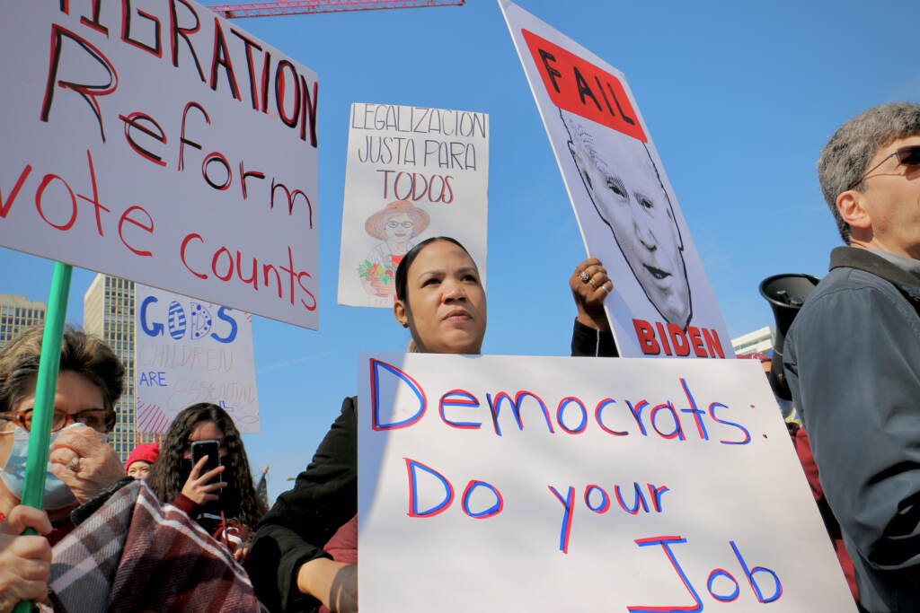 2022 03 11-e lee-philadelphia hilton-biden immigration reform protest justa para todos Immigration reform activists wait for President Biden across the street from the Hilton Philadelphia, where he addressed the House Democratic Caucus. (Emma Lee/WHYY)