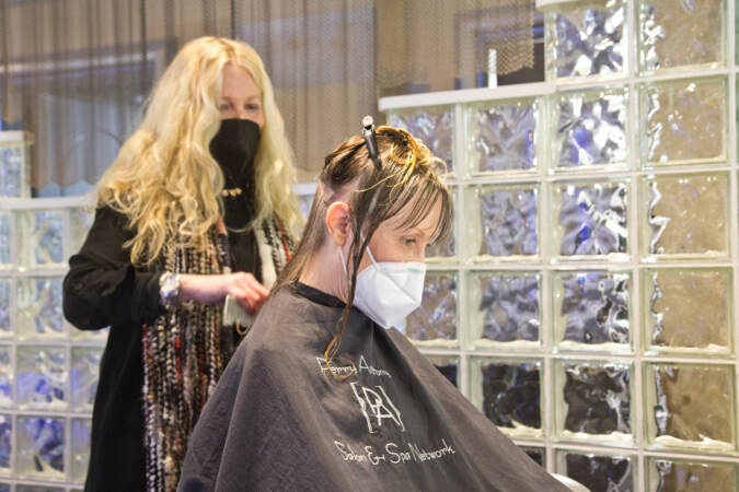 Judy Kozulak had her hair cut and styled for the first time since the COVID-19 pandemic started by stylist Lorraine Keane at Perry Anthony Salon & Spa in Wilmington, Del., on March 14, 2022. Kouzulak is severely immunocompromised, and hasn’t been inside public spaces since 2020. (Kimberly Paynter/WHYY)