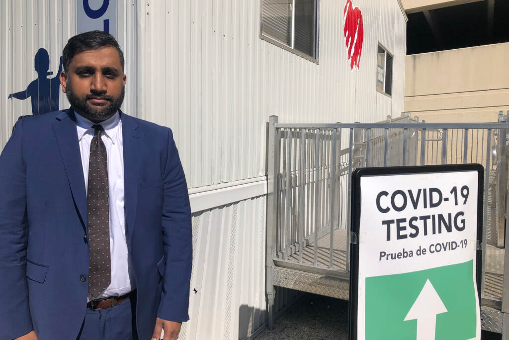 2022-03-21-n-feldman-azmat-husain Azmat Husain stands at a COVID-19 testing site