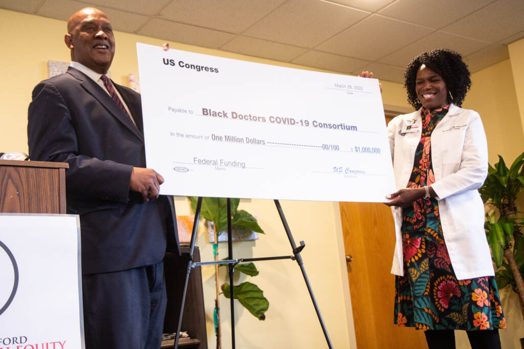 2022 03 28 kpaynter center for health equity funding dr. ala stanford dwight evans-4 Dr. Ala Stanford (right) accepted part of $3 million in funding from Community Project Funding from Congressman Dwight Evans (left) at the Center for Health Equity on March 28, 2022. (Kimberly Paynter/WHYY)