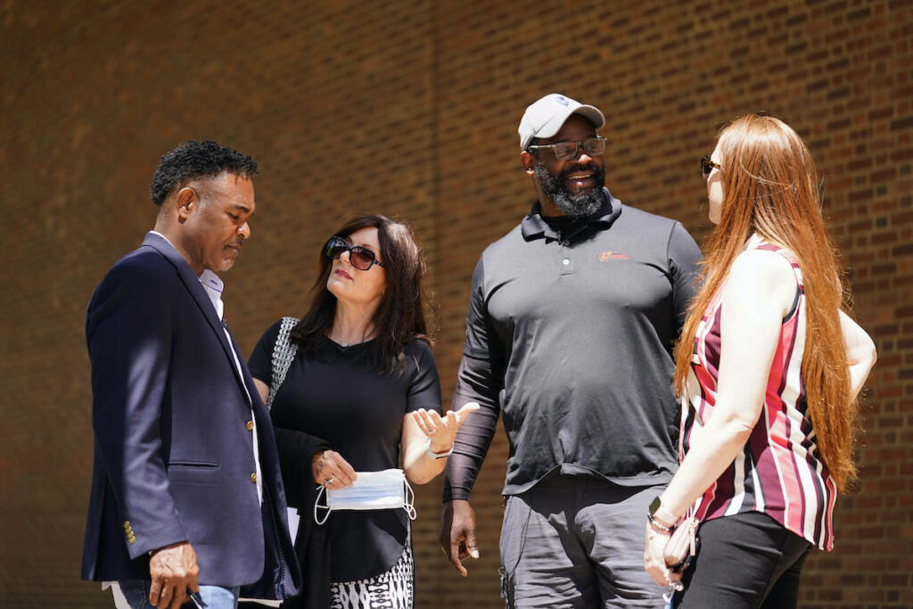Ken Jenkins, Amy Lewis, Clarence Vaughn III, Brooke Vaughn File photo: (From left) former NFL player Ken Jenkins and his wife Amy Lewis, along with former NFL player Clarence Vaughn III and his wife Brooke Vaughn, meet before delivering tens of thousands of petitions demanding equal treatment for everyone involved in the settlement of concussion claims against the NFL, to the federal courthouse in Philadelphia, Friday, May 14, 2021. (AP Photo/Matt Rourke)