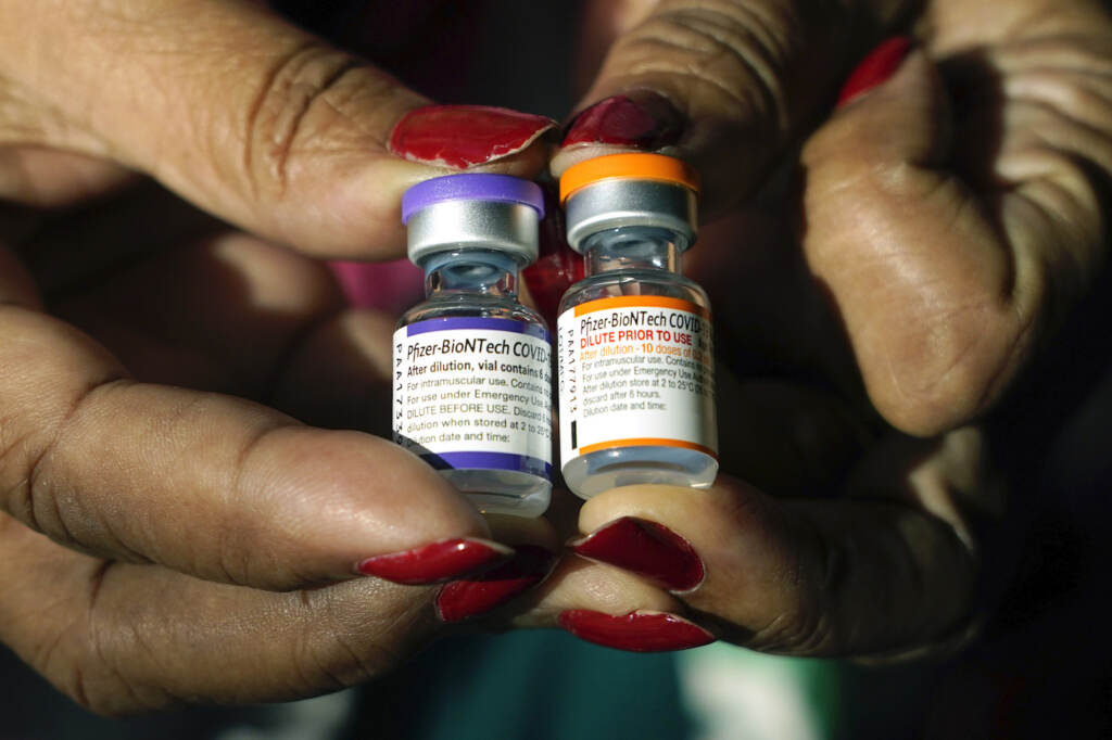 Jackson-Hinds Comprehensive Health Center nurse Maggie Bass holds a vial of the Pfizer COVID-19 vaccine