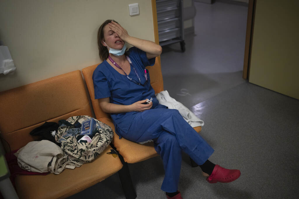 Virus Outbreak 6 Million Deaths FILE - Nurse Marie-Laure Satta pauses during her New Year's Eve shift in the COVID-19 intensive care unit at the la Timone hospital in Marseille, southern France, Friday, Dec. 31, 2021. The official global death toll from COVID-19 is on the verge of eclipsing 6 million — underscoring that the pandemic, now in its third year, is far from over. (AP Photo/Daniel Cole, File)
