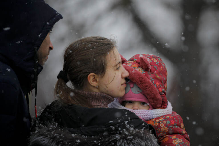 A woman fleeing the conflict from neighbouring Ukraine holds her baby at the Romanian-Ukrainian border, in Siret, Romania, Thursday, March 3, 2022. The number of people sent fleeing Ukraine by Russia's invasion topped 1 million on Wednesday, the swiftest refugee exodus this century, the United Nations said.. (AP Photo/Andreea Alexandru)