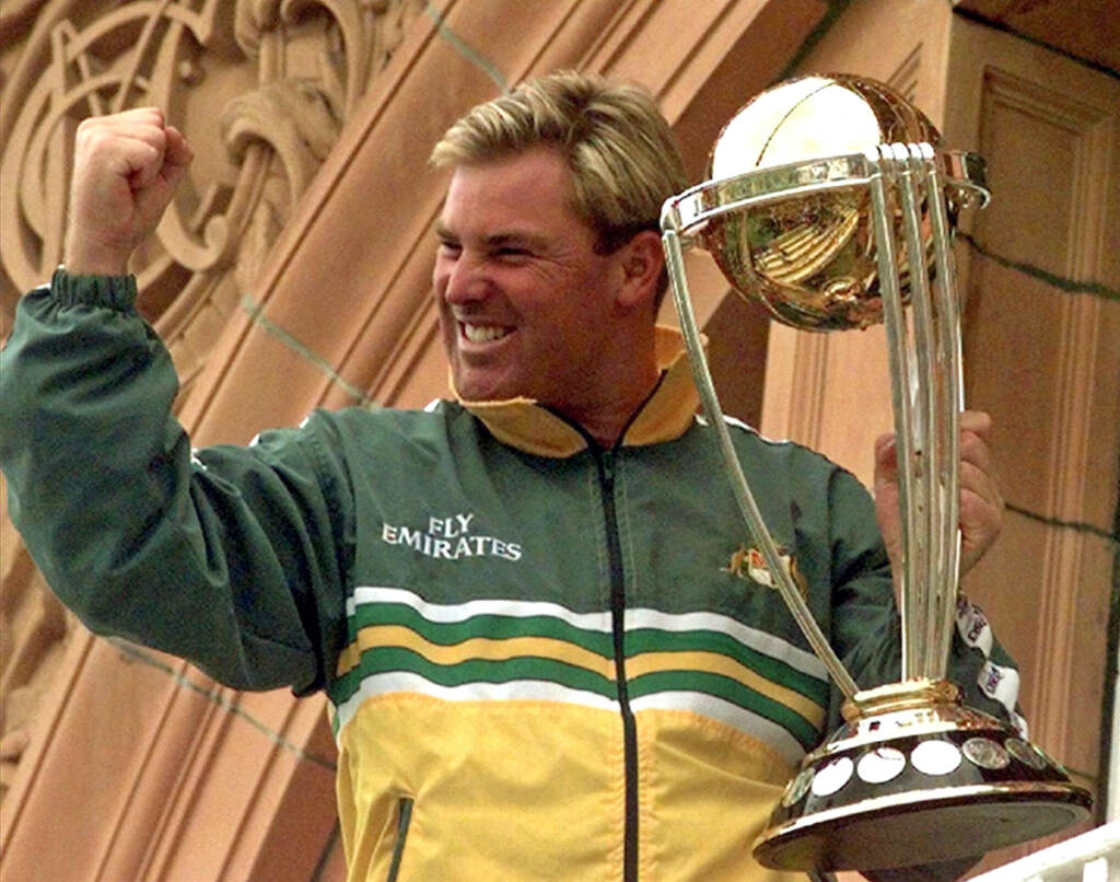 Obit Australia Shane Warne File photo: Australia's Shane Warne clenches his fist as he holds the Cricket World Cup Trophy on the team balcony at Lords after Australia defeated Pakistan by 8 wickets in the final of the Cricket World Cup, in London Sunday, June 20, 1999. Shane Warne, one of the greatest cricket players in history, has died. He was 52. (AP Photo/Rui Vieira, File)