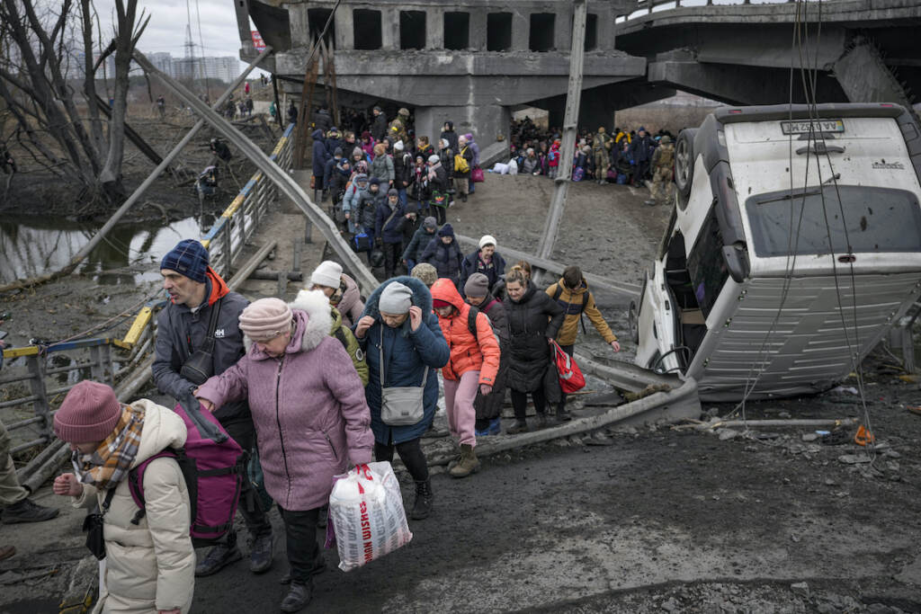 APTOPIX Russia Ukraine War People cross on an improvised path under a bridge that was destroyed by a Russian airstrike, while fleeing the town of Irpin, Ukraine, Saturday, March 5, 2022. What looked like a breakthrough cease-fire to evacuate residents from two cities in Ukraine quickly fell apart Saturday as Ukrainian officials said shelling had halted the work to remove civilians hours after Russia announced the deal.