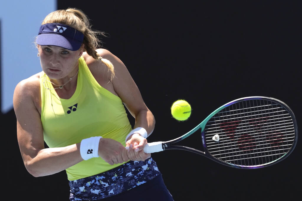 Dayana Yastremska of Ukraine plays a backhand return to Madison Brengle of the U.S. during their first round match at the Australian Open tennis championships in Melbourne, Australia, Monday, Jan. 17, 2022. (AP Photo/Simon Baker)