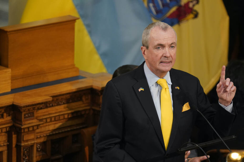 Phil Murphy Standing in front of the flags of New Jersey, and Ukraine, New Jersey Gov. Phil Murphy speaks during his budget address in Trenton, N.J., Tuesday, March 8, 2022. (AP Photo/Seth Wenig)
