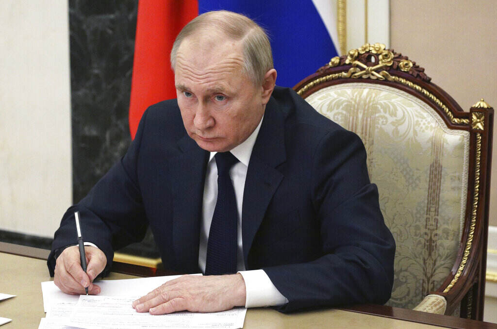 Russia Putin Russian President Vladimir Putin sits at a table