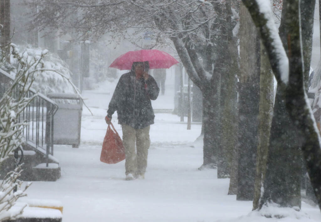 Winter Weather A man walks through Lancaster City, Pa., with his shopping bag during a snowstorm Saturday, March 12, 2022. Much of the northeast is experiencing a late winter storm dropping snow and high winds