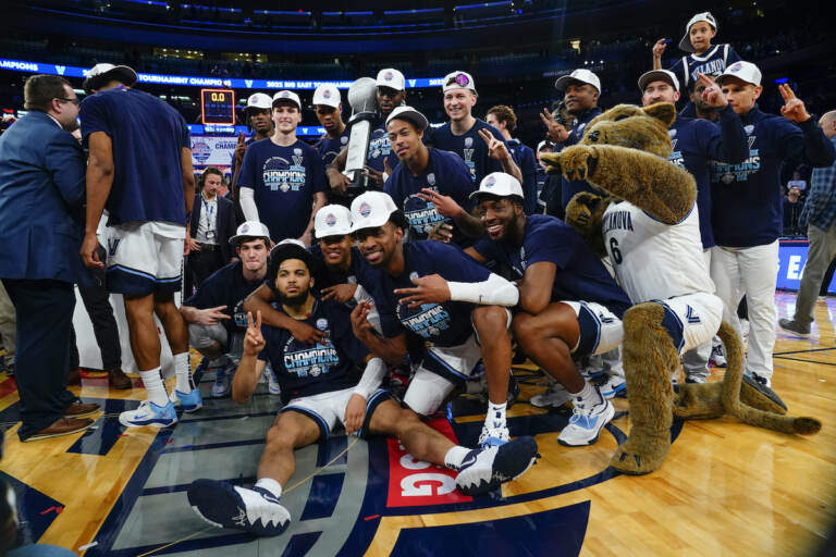 Villanova players pose with the tournament trophy after defeating Creighton in the final of the Big East conference tournament Saturday, March 12, 2022, in New York