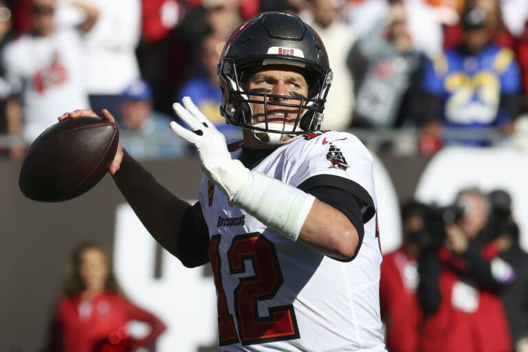 File photo: Tampa Bay Buccaneers quarterback Tom Brady (12) throws a pass against the Los Angeles Rams during the first half of an NFL divisional round playoff football game Jan. 23, 2022, in Tampa, Fla. Brady’s retirement lasted 40 days. He said Sunday, March 13, 2022, he is returning to the Buccaneers for his 23rd season in the NFL