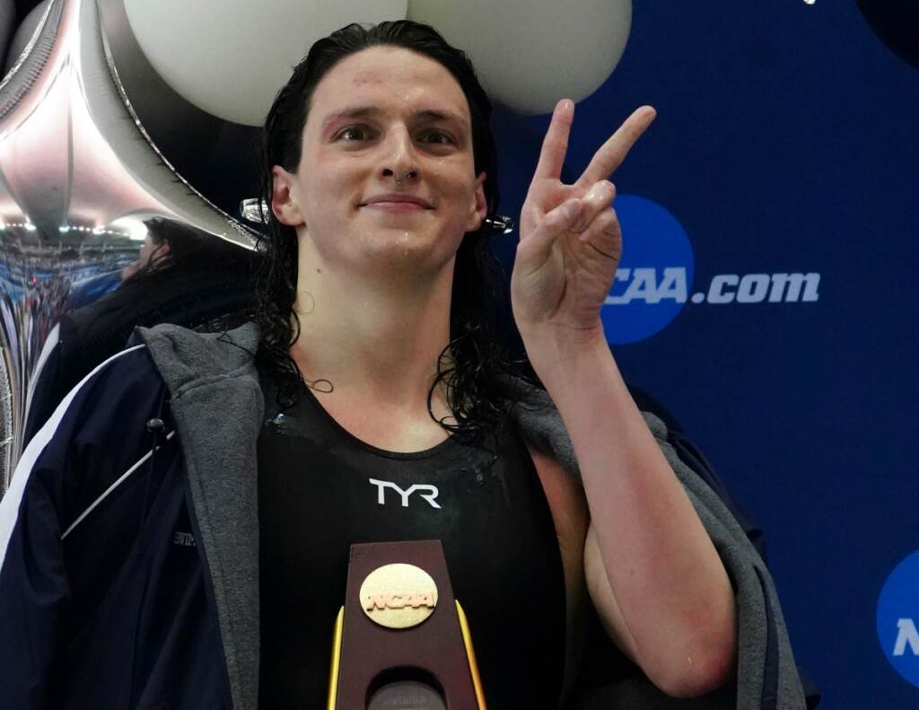 AP22076819400728 (1) Pennsylvania's Lia Thomas gestures as she holds the trophy after winning the 500-yard freestyle at the NCAA swimming and diving championships Thursday, March 17, 2022, at Georgia Tech in Atlanta. Thomas is the first known transgender woman to win an NCAA swimming championship