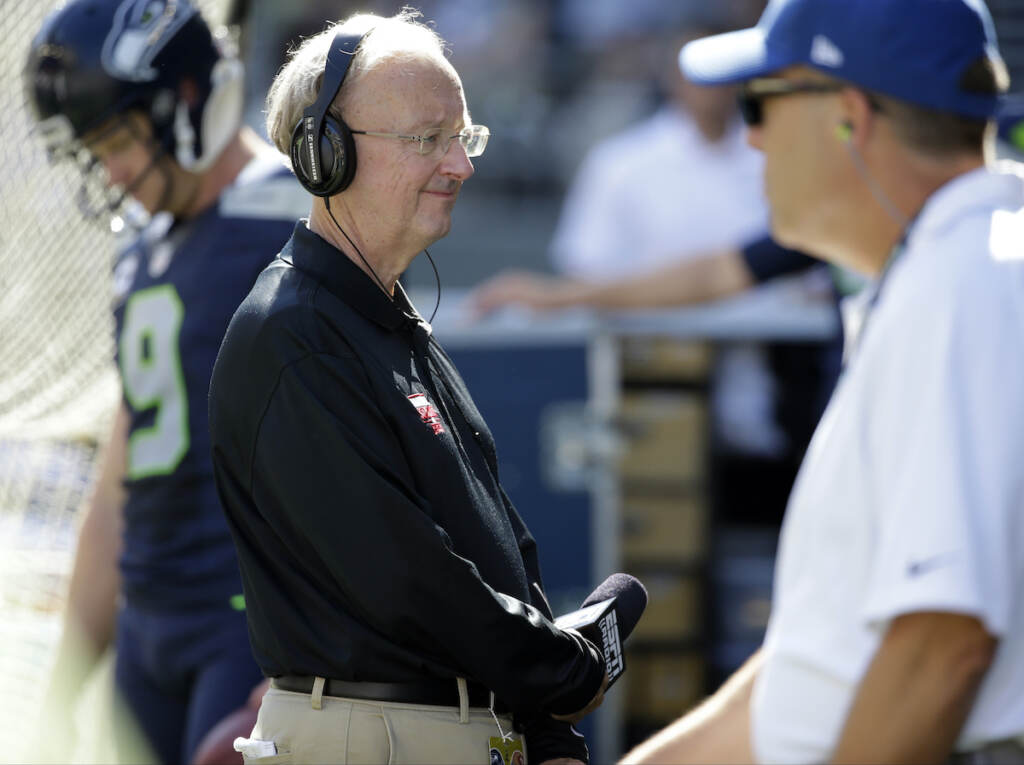 Obit Clayton Football John ''The Professor'' Clayton, an NFL football writer and reporter for ESPN, stands on the sideline during an NFL football game between the Seattle Seahawks and the San Francisco 49ers, Sunday, Sept. 25, 2016, in Seattle. (AP Photo/Ted S. Warren)