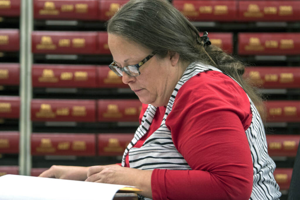 Kim Davis, the county clerk for Rowan County in Kentucky, works with the county election board on Election Day, Tuesday, Nov. 6, 2018, in Morehead, Ky. (AP Photo/John Flavell)