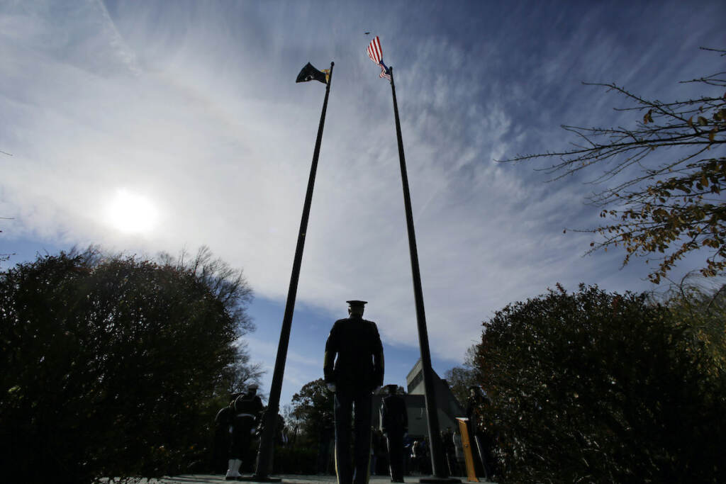 Military personnel stand at attention during Veterans Day ceremonies