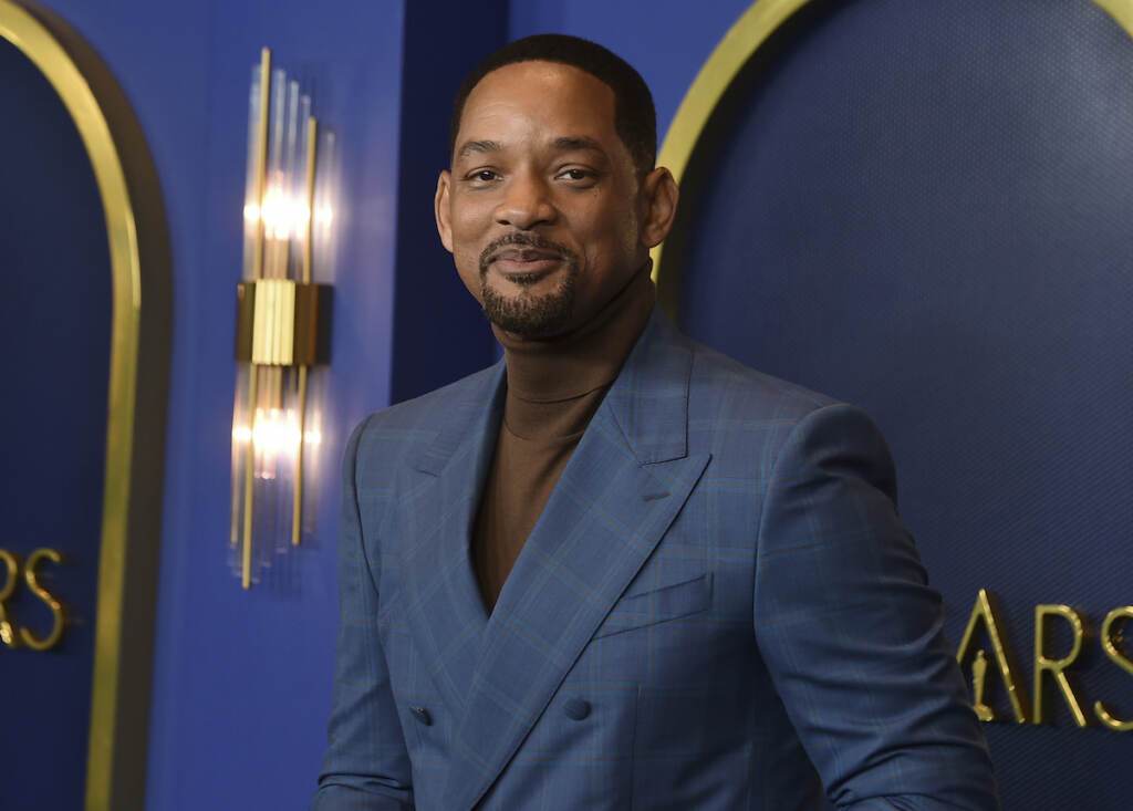 Will Smith Will Smith, wearing a brown turtleneck and a dark blue plaid suit jacket, is posing in front of a dark blue background at the 94th Academy Awards nominees luncheon on Monday, March 7, 2022, in Los Angeles.