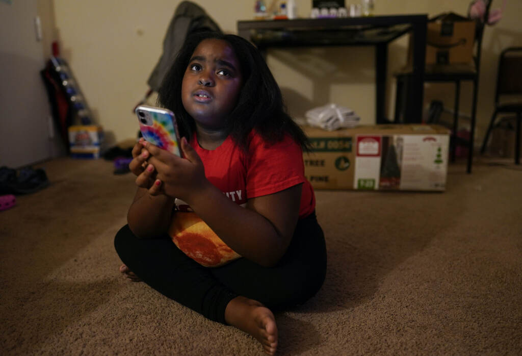 Danielle Chiles Brooklynn Chiles glances up from her smart phone at home