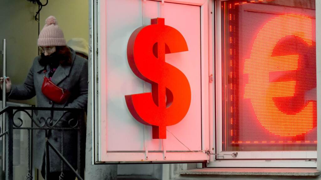 A woman leaves a currency exchange office in Saint Petersburg, Russia, on Wednesday. Russian authorities are scrambling to stem panic as massive sanctions over Moscow’s invasion of Ukraine are delivering Russia’s worst economic shocks since the fall of the Soviet Union. A woman leaves a currency exchange office in Saint Petersburg, Russia, on Wednesday. Russian authorities are scrambling to stem panic as massive sanctions over Moscow's invasion of Ukraine are delivering Russia's worst economic shocks since the fall of the Soviet Union. (Olga Maltseva/AFP via Getty Images)