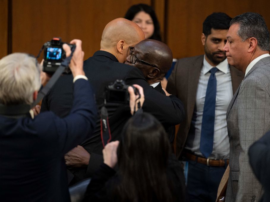 U.S. Sen. Cory Booker hugs Johnny Brown, the father of Judge Ketanji Brown Jackson