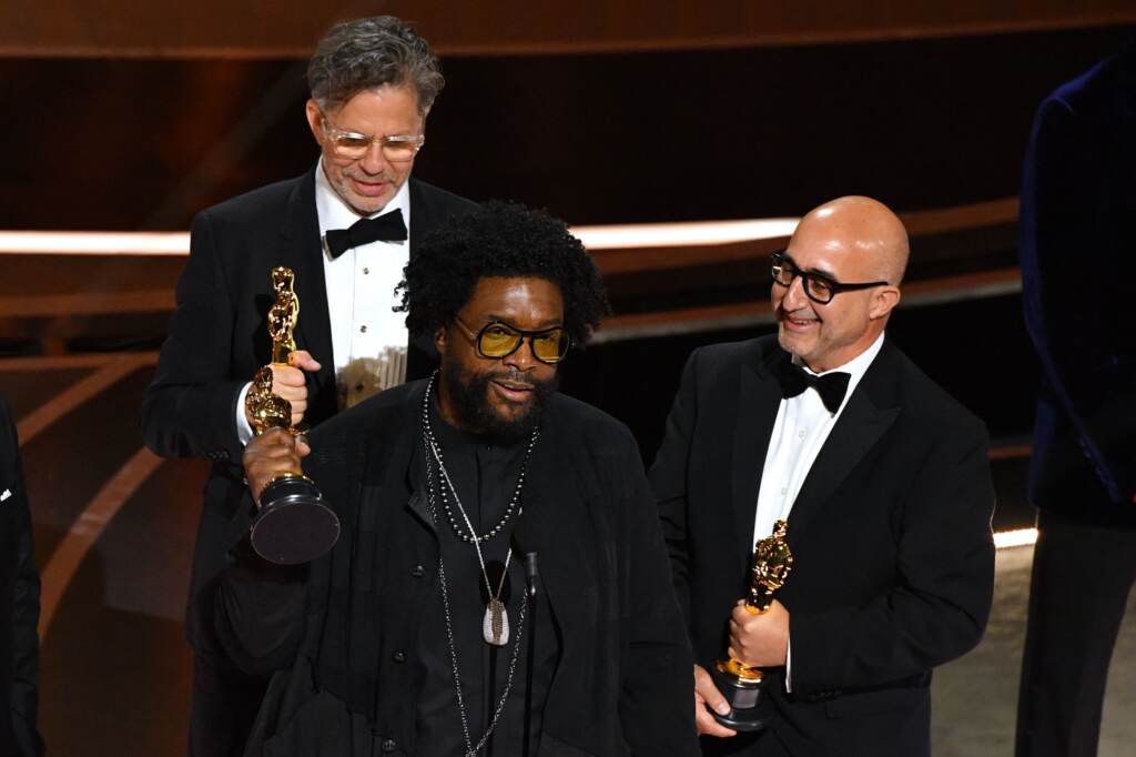 Ahmir “Questlove” Thompson (C), Robert Fyvolent (L) and David Dinerstein (R) accept the Oscar for best documentary feature for Summer of Soul. Ahmir 'Questlove' Thompson (C), Robert Fyvolent (L) and David Dinerstein (R) accept the Oscar for best documentary feature for Summer of Soul. (Robyn Beck/AFP via Getty Images)