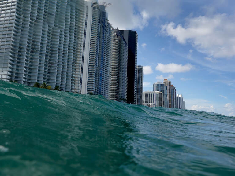 Waves lap ashore near condo buildings in Sunny Isles, Fl., on Aug. 9, 2021.