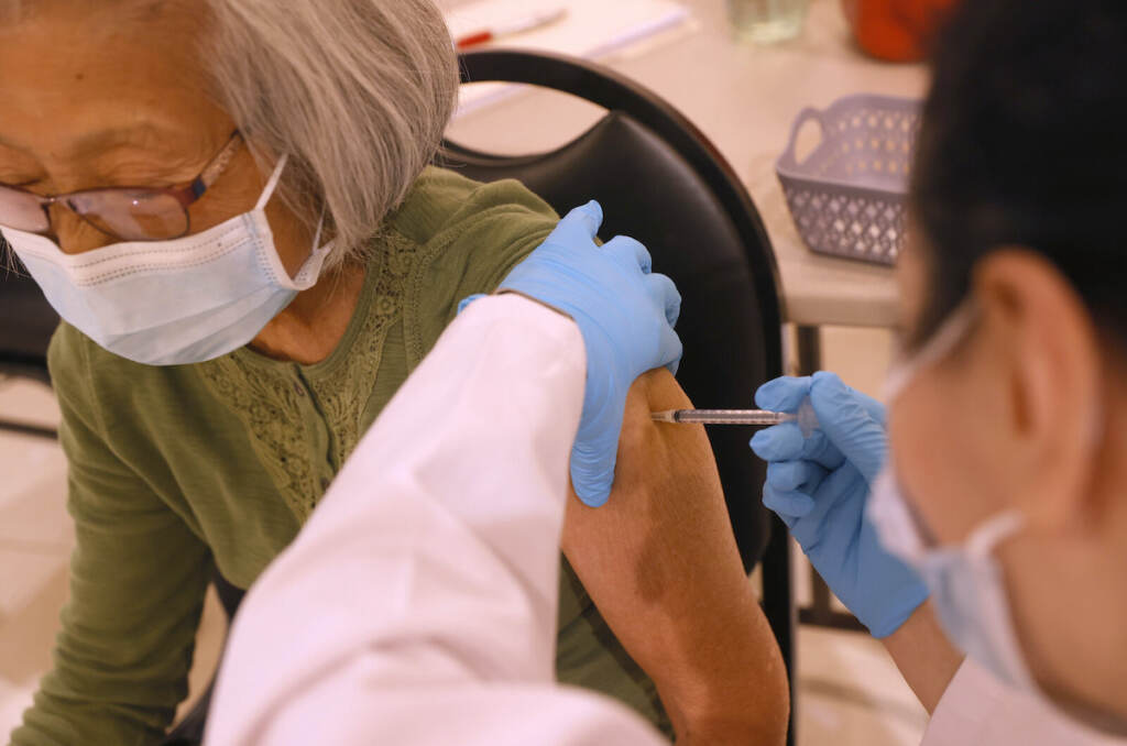 Vaccination Clinic Administers Booster Shots In California A health worker administers a COVID-19 vaccine shot
