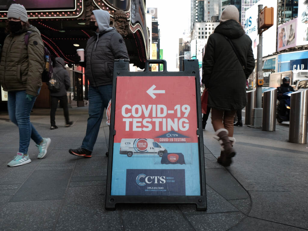 People pass a COVID-19 testing site on a Manhattan street on Jan. 21. The White House says it is running out of money to pay for COVID tests for people who don’t have insurance. People pass a COVID-19 testing site on a Manhattan street on Jan. 21. The White House says it is running out of money to pay for COVID tests for people who don't have insurance. (Spencer Platt/Getty Images)