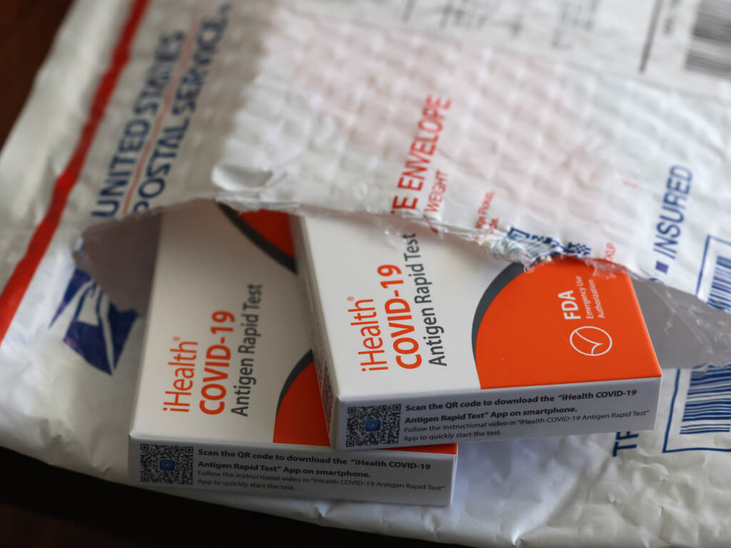 In this photo illustration, free iHealth COVID-19 antigen rapid tests from the federal government sit on a U.S. Postal Service envelope after being delivered on Feb. 4, 2022. In this photo illustration, free iHealth COVID-19 antigen rapid tests from the federal government sit on a U.S. Postal Service envelope after being delivered on Feb. 4, 2022. (Justin Sullivan/Getty Images)