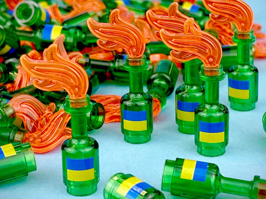 Mini figurines based on Molotov cocktails, featuring the Ukrainian flag