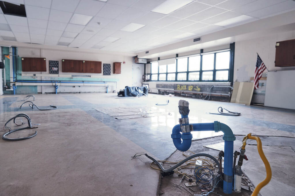 A schoolroom, stripped of furniture, awaits repair.