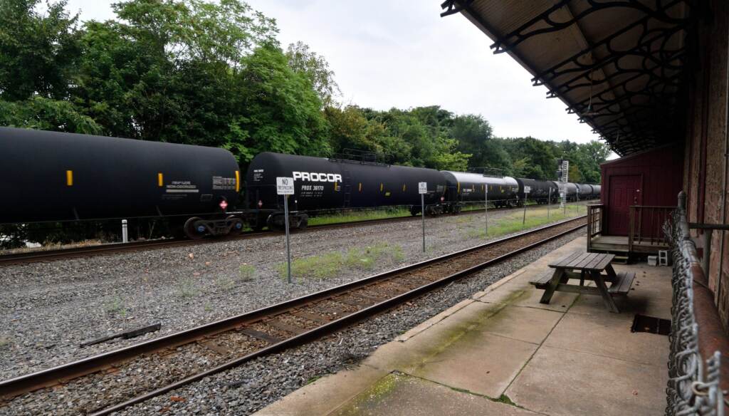 phoenixville-rail-expansion-plan-BS-082118 A black freight train, operated by Norfolk Souther, speeds by on a track, as seen from the former train station in Phoenixville, PA.