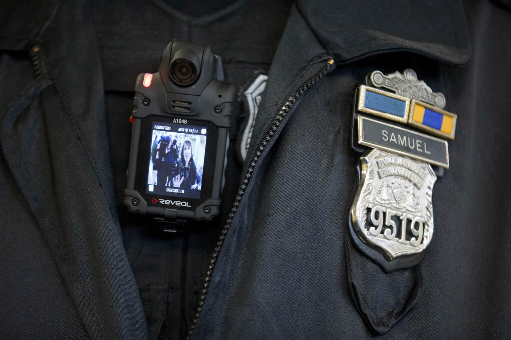 Open Records Survey FILE – In this Dec. 11, 2014, file photo, a Philadelphia police officer demonstrates a body-worn camera used as part of a pilot project in Philadelphia. Government offices across Pennsylvania didn't apply the state's Right-to-Know Law uniformly, according to a May 2016 survey by 21 newspapers. Dash-cam videos have fueled a national debate on police policies and tactics, but in Pennsylvania those images remain largely out of sight, thanks to state laws that give law enforcement broad power to keep out of public view anything considered to be investigative material. (AP Photo/Matt Rourke, File)