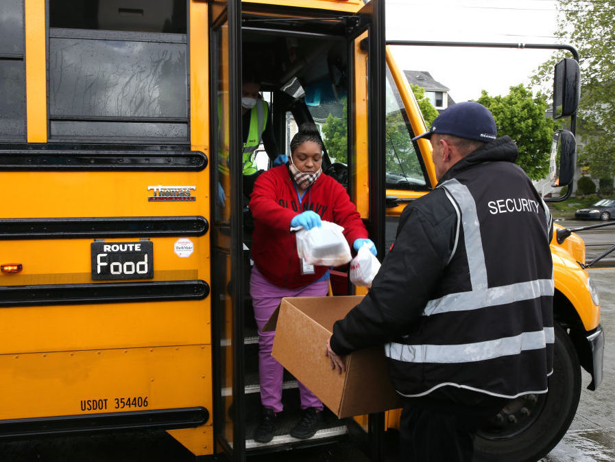 Nutritionist Shaunté Fields and bus driver Treva White, left, deliver meals to children and their families in Seattle. When schools closed because of COVID-19, Seattle Public Schools began distributing breakfast and lunch to students through a network of 26 school sites and 43 bus routes five days a week. Nutritionist Shaunté Fields and bus driver Treva White (left) deliver meals to children and their families