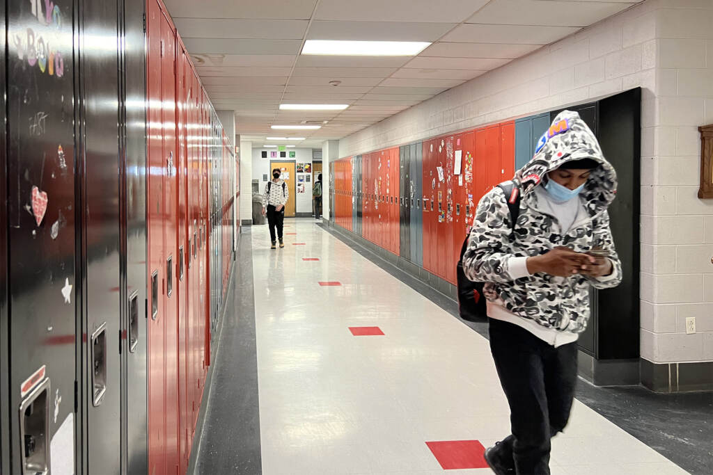 schoolstudents-masking Students wear masks as they walk through a hallway at CAPA.
