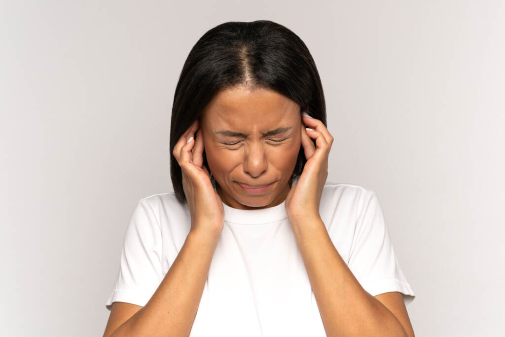 the-pulse-bigstock-Annoyed-Irritated-Young-Female-437555570 A young woman plugging her ears to block out noise