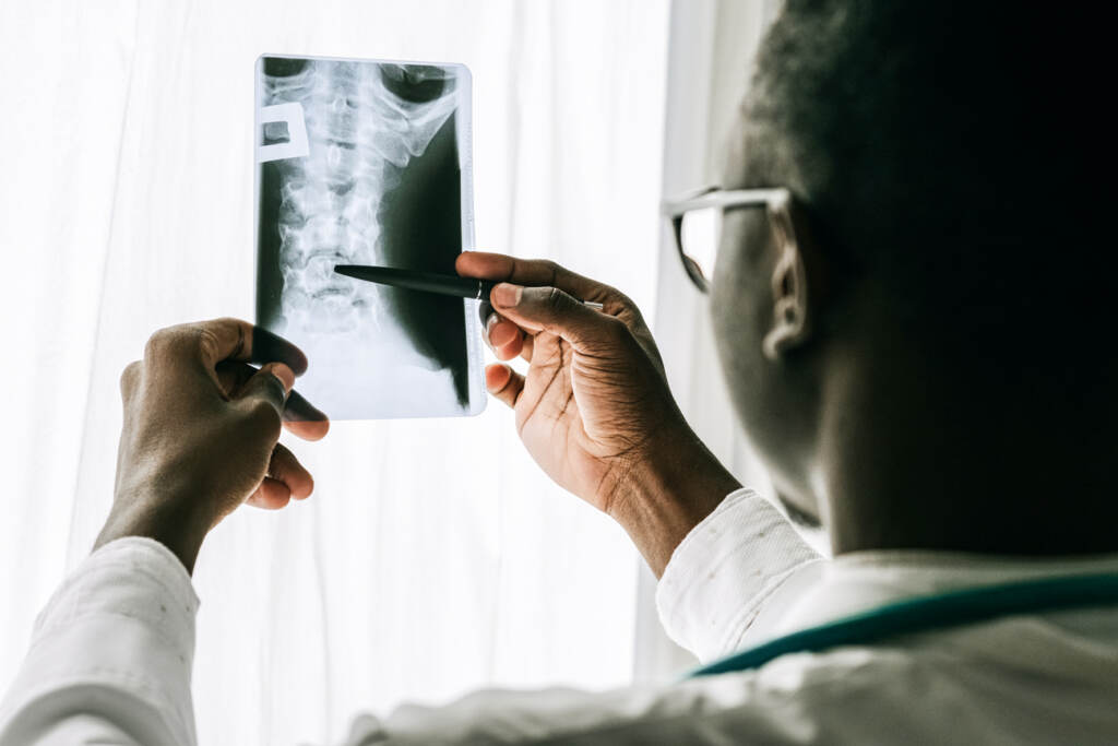 the-pulse-pexels-ivan-samkov-4989186 A doctor looking at an x-ray