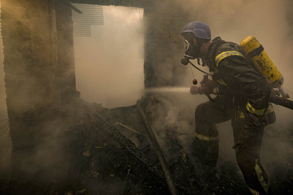 Russia Ukraine War A Ukrainian firefighter sprays water inside a house destroyed by bombing in Kyiv