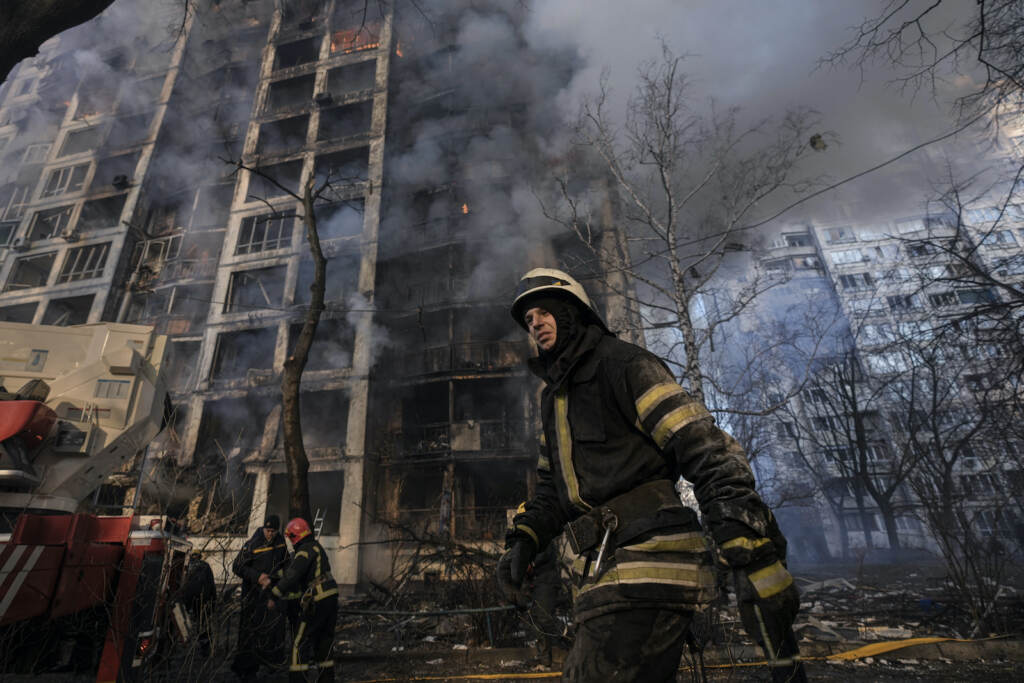 APTOPIX Russia Ukraine War A firefighter walks outside a destroyed apartment building after a bombing in a residential area in Kyiv