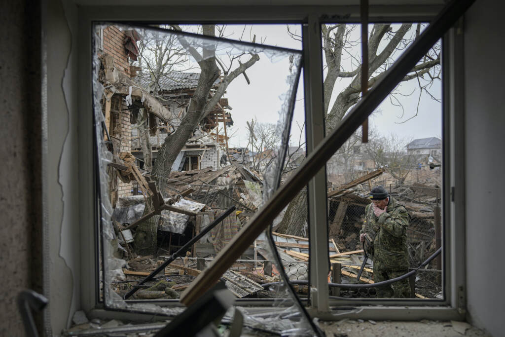 APTOPIX Russia Ukraine War Andrey Goncharu wipes his face in the backyard of a damaged house