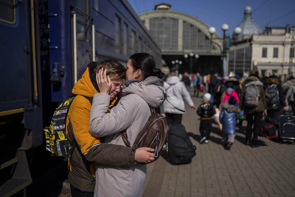 APTOPIX Russia Ukraine War At the train station in Lviv, Ukraine, a mother embraces her son who escaped the besieged city of Mariupol.