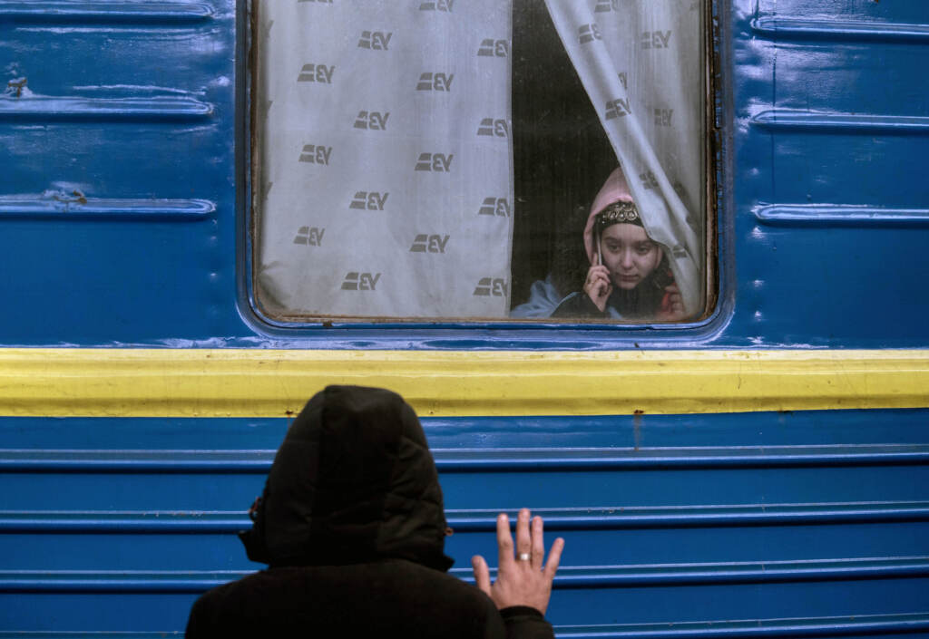 Refugees flee fighting A father waves goodbye to his daughter as she departs on a train to Poland