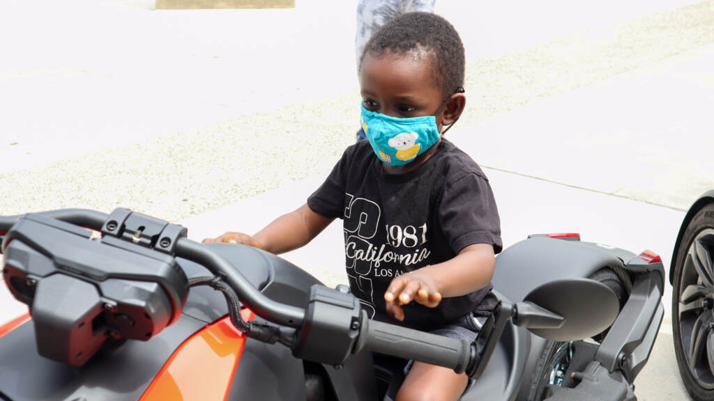 urbannavigators-01crop A toddler poses on a stationary bike